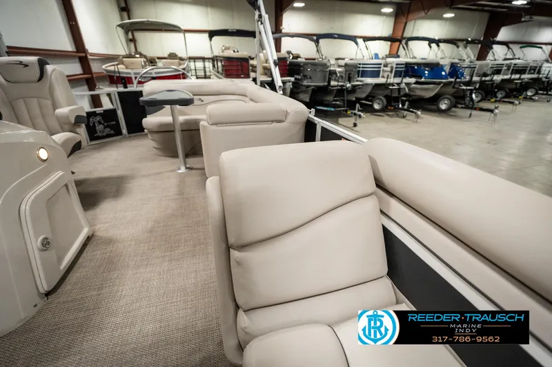 Slide: The Image of 2019 Bennington 21 SLX pontoon boat interior with beige seating in showroom. - 20