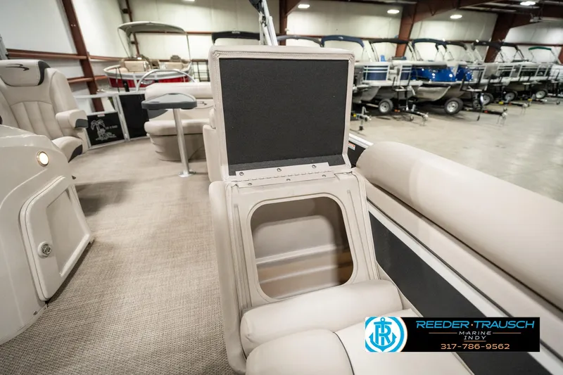 Slide: The Image of 2019 Bennington 21 SLX pontoon boat interior with open storage compartment. - 21