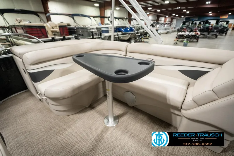 Slide: The Image of 2019 Bennington 21 SLX pontoon boat interior with beige seating and table. - 22