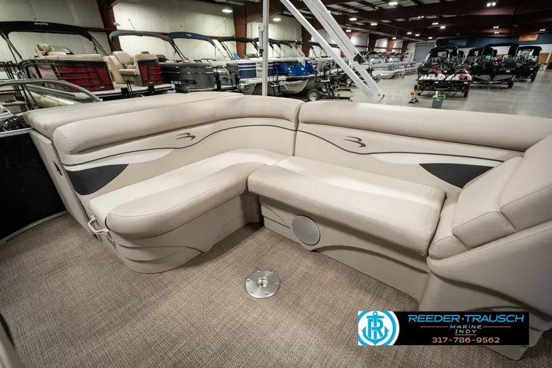 Slide: The Image of 2019 Bennington 21 SLX pontoon boat interior with beige seating in showroom. - 23