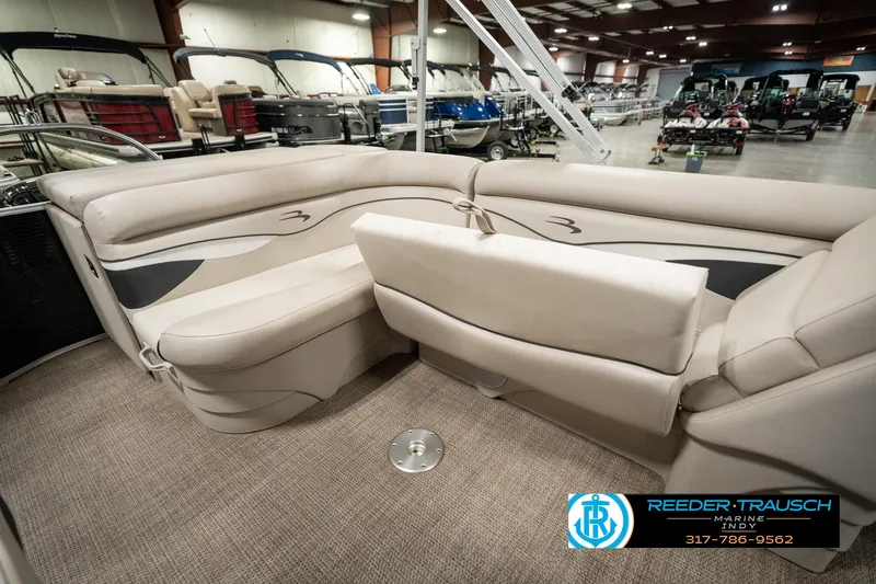 Slide: The Image of 2019 Bennington 21 SLX pontoon boat interior with beige seating in showroom. - 24