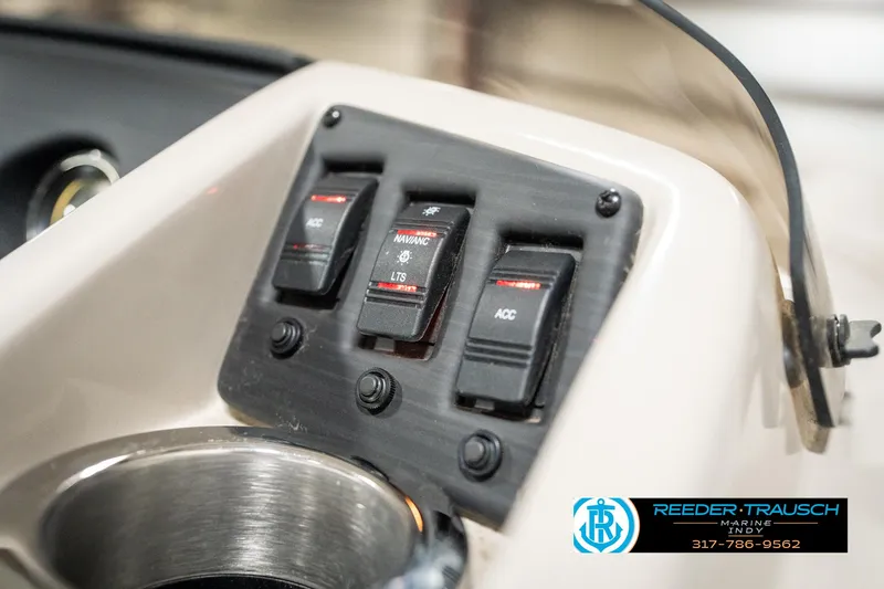 Slide: The Image of Control panel of 2019 Bennington 21 SLX boat with switches and cup holder. - 35