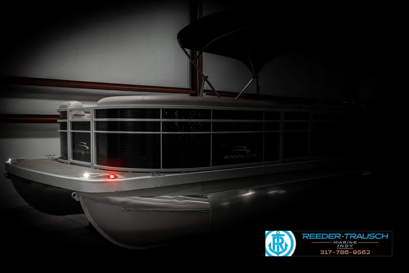 Slide: The Image of 2019 Bennington 21 SLX pontoon boat in dimly lit showroom. - 4