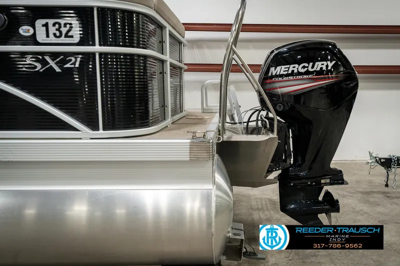 Slide: The Image of 2019 Bennington 21 SLX pontoon boat with Mercury outboard motor in showroom. - 45