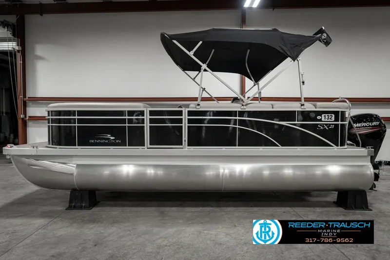 Slide: The Image of 2019 Bennington 21 SLX pontoon boat with black canopy in showroom. - 5