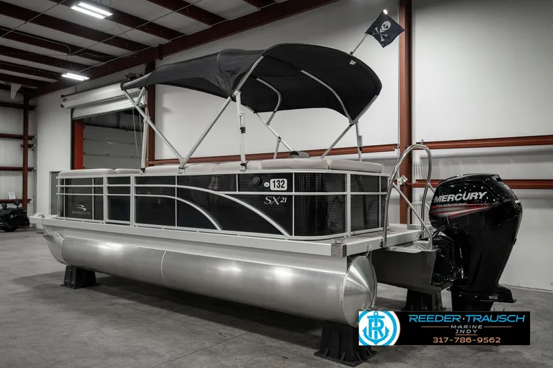Slide: The Image of 2019 Bennington 21 SLX pontoon boat with Mercury engine in indoor storage. - 6