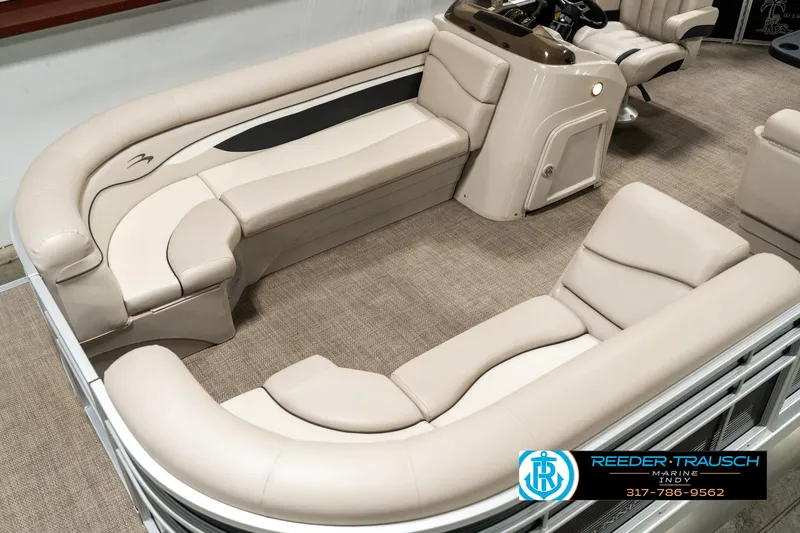 Slide: The Image of 2019 Bennington 21 SLX pontoon boat interior with beige seating and carpeted flooring. - 9