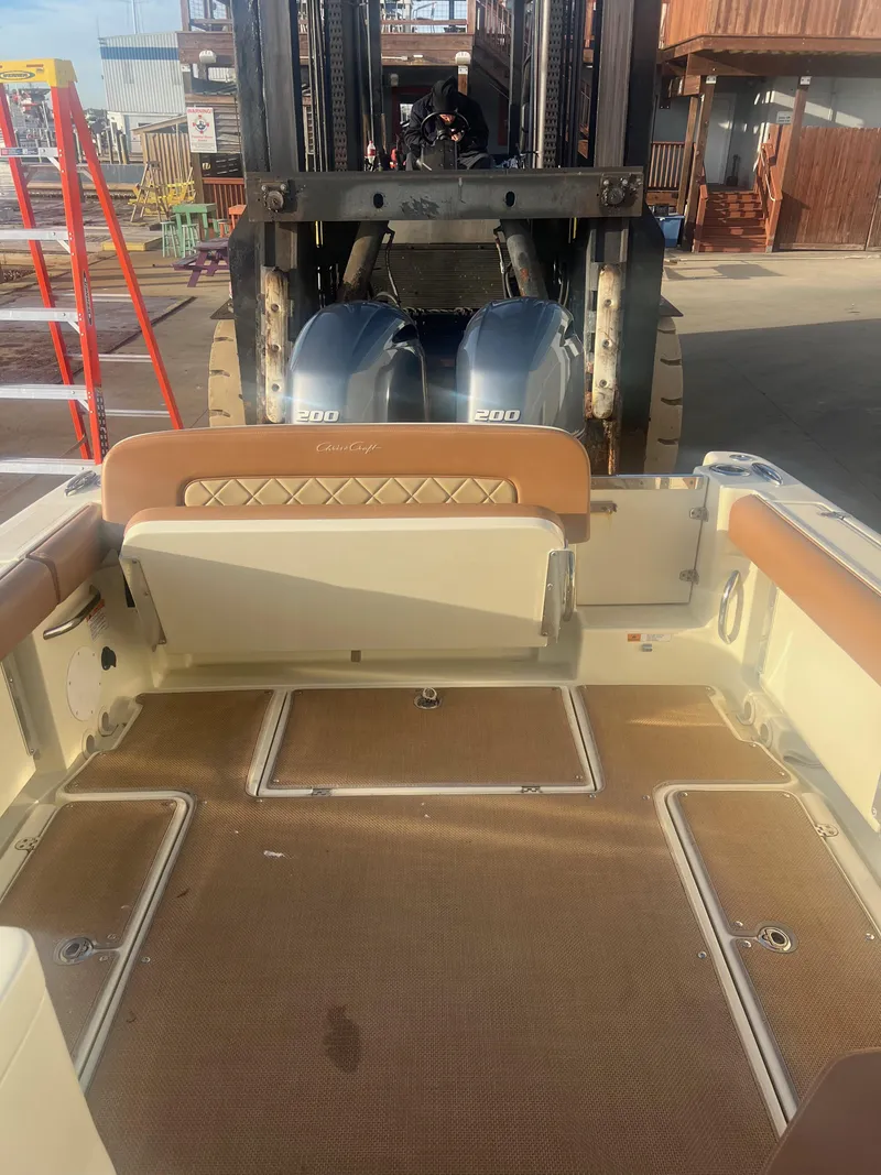 Slide: The Image of 2017 Chris-Craft Calypso boat interior with forklift in background. - 10