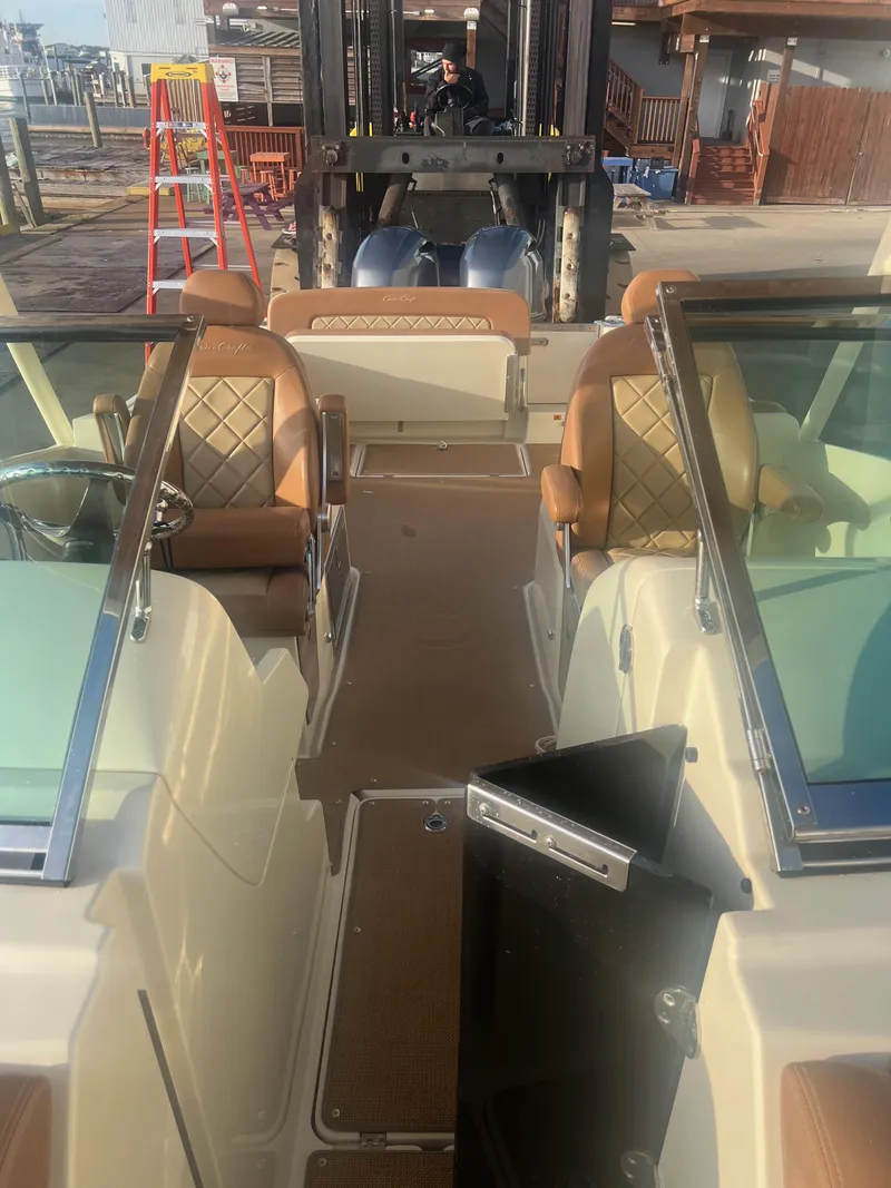 Slide: The Image of 2017 Chris-Craft Calypso boat interior with tan leather seats and dual windshields. - 11