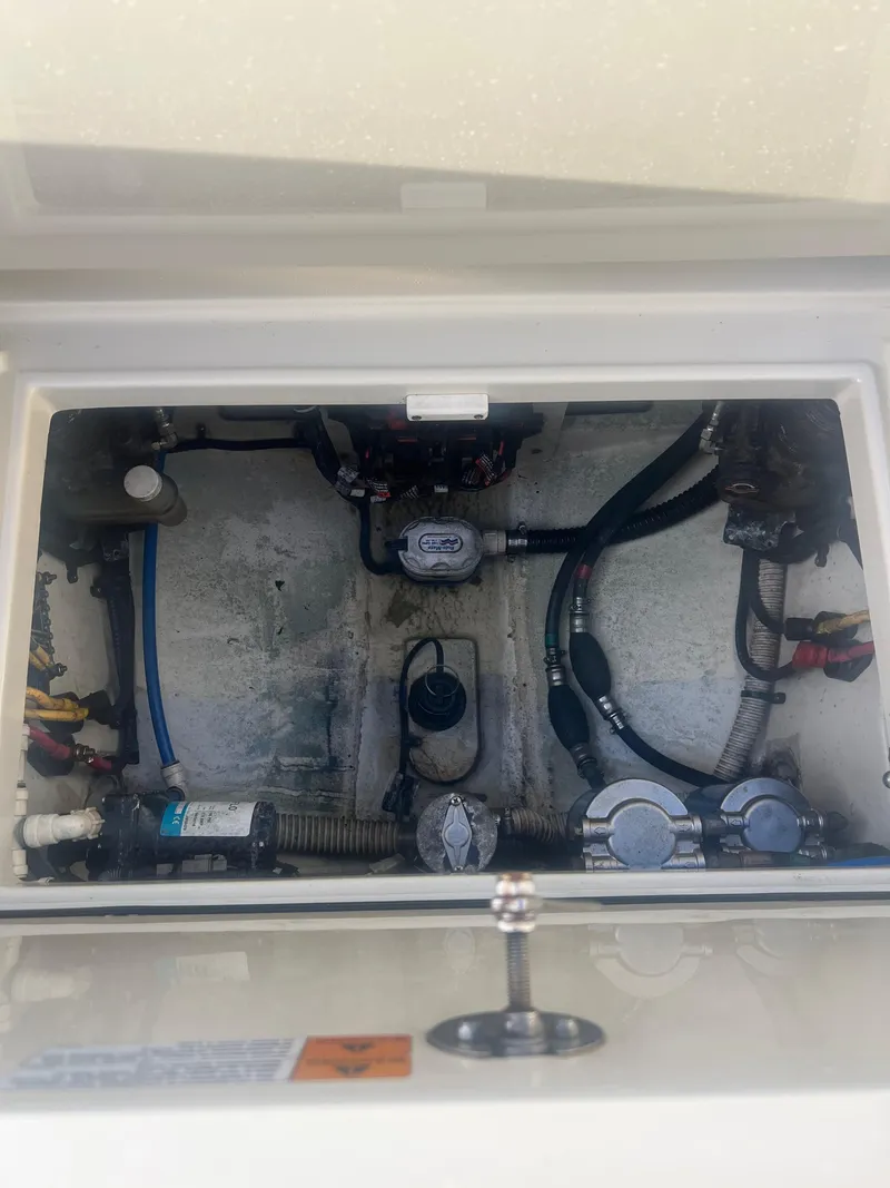 Slide: The Image of 2017 Chris-Craft Calypso engine compartment with visible wiring and components. - 12