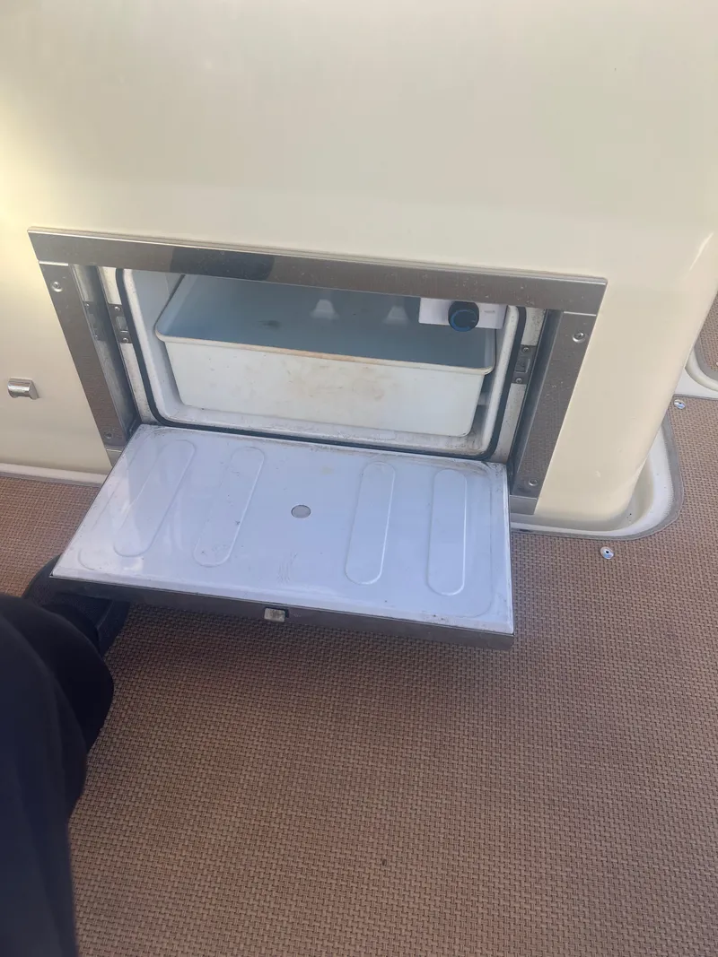 Slide: The Image of 2017 Chris-Craft Calypso boat storage compartment with open hatch on deck. - 13