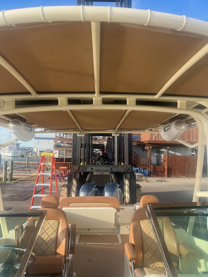 Slide: The Image of 2017 Chris-Craft Calypso boat interior with tan seating and canopy, dockside view. - 6