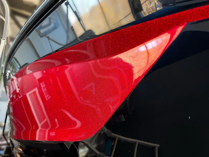 Slide: The Image of Close-up of 2025 MasterCraft X22 boat with sleek red and black design. - 1