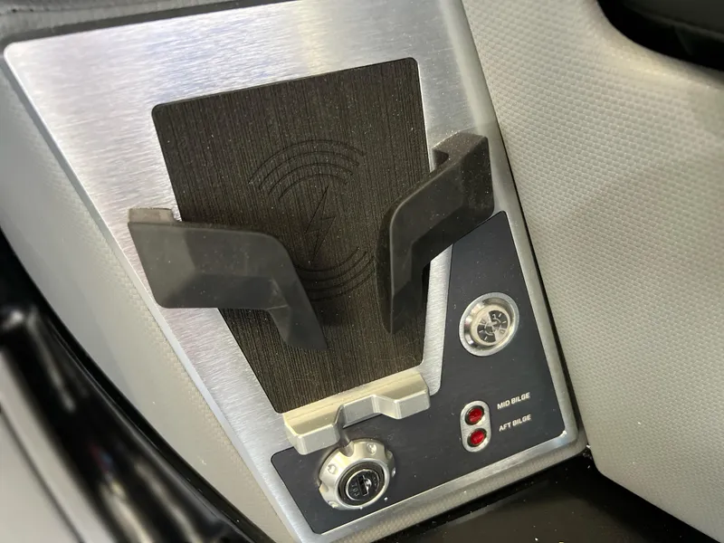 Slide: The Image of 2025 MasterCraft X22 boat control panel with cup holder and switches. - 10