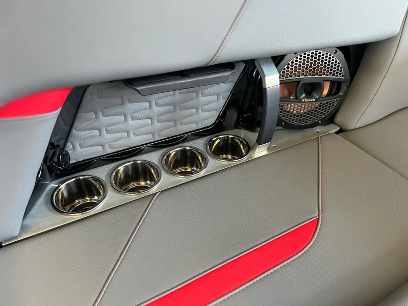 Slide: The Image of 2025 MasterCraft X22 interior with cup holders and speaker detail. - 13