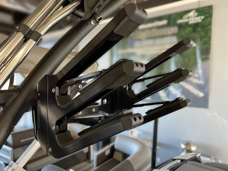 Slide: The Image of 2025 MasterCraft X22 wakeboard rack, sleek black design, mounted on boat. - 16