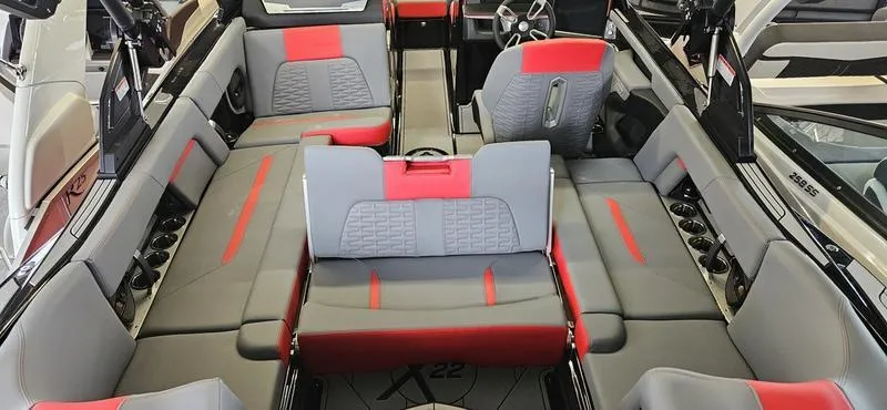 Slide: The Image of 2025 MasterCraft X22 interior with gray and red seating, modern design. - 7