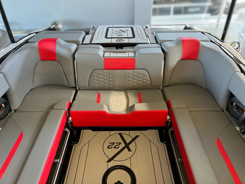 Slide: The Image of 2025 MasterCraft X22 boat interior with gray and red seating, stylish design. - 8