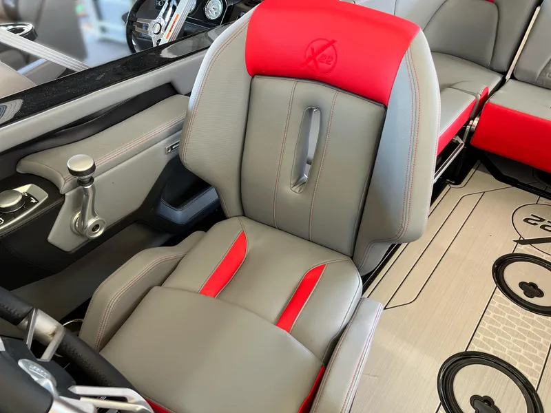 Slide: The Image of 2025 MasterCraft X22 boat interior with red and gray seating. - 9