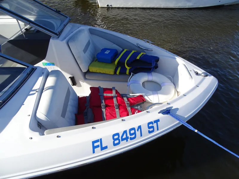 Slide: The Image of 2021 Regal 1900 ES Bowrider with life jackets and safety gear on deck. - 10