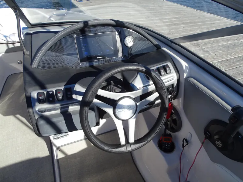 Slide: The Image of 2021 Regal 1900 ES Bowrider dashboard with steering wheel and controls. - 2