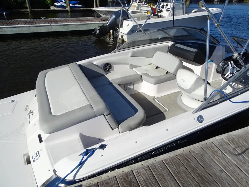 Slide: The Image of 2021 Regal 1900 ES Bowrider boat with spacious seating at a dock. - 7