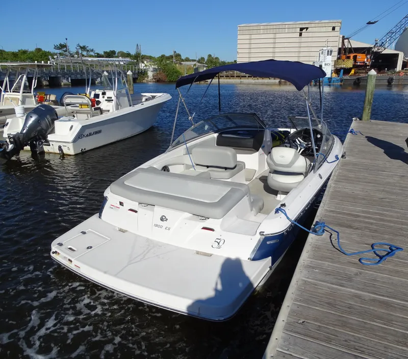Slide: The Image of 2021 Regal 1900 ES Bowrider docked at marina with blue canopy. - 8