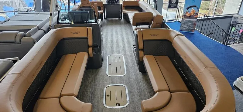 Slide: The Image of 2025 Bennington 24 MFB boat interior with luxurious tan seating and modern design. - 2