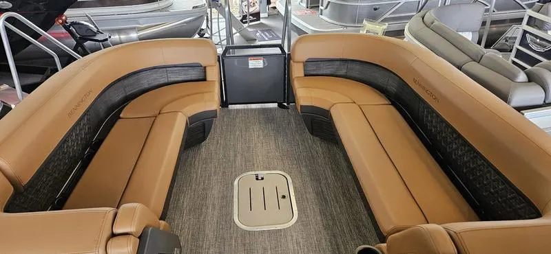 Slide: The Image of 2025 Bennington 24 MFB pontoon boat interior with tan seating and carpeted flooring. - 5