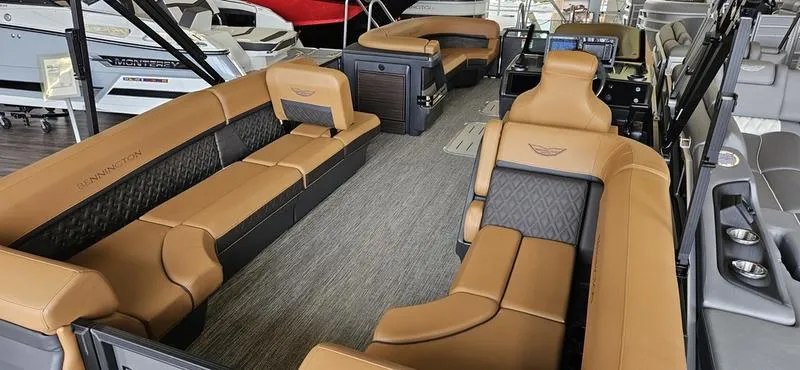 Slide: The Image of 2025 Bennington 24 MFB pontoon boat interior with luxurious tan seating and modern design. - 9