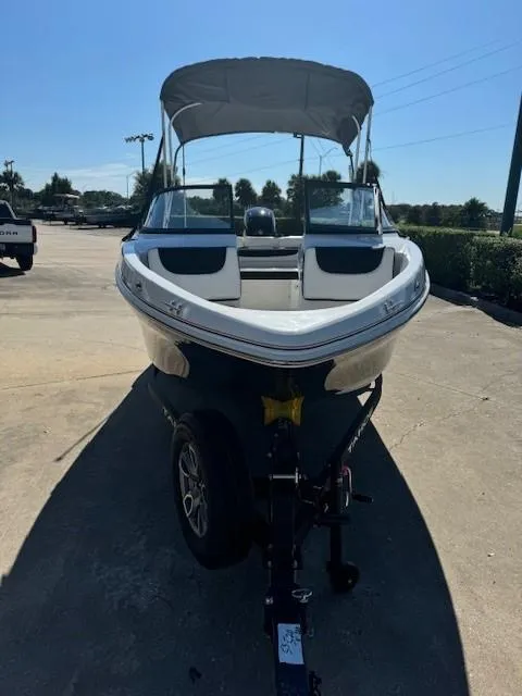 Slide: The Image of 2025 Tahoe 200 S boat with canopy on trailer in sunny outdoor setting. - 2