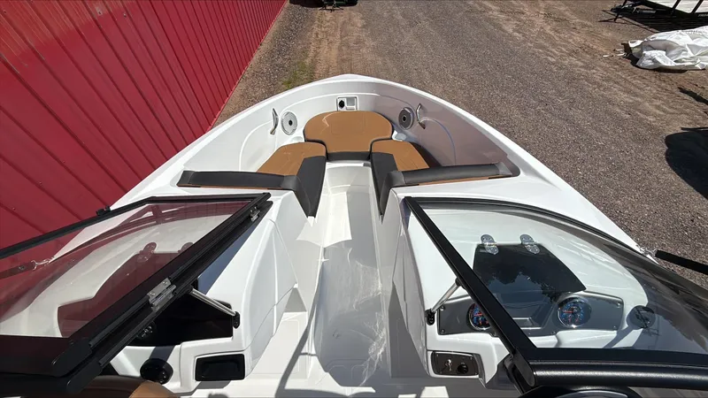 Slide: The Image of 2025 Tahoe 200 S boat interior with open windshield and seating area. - 2