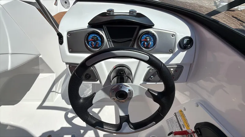 Slide: The Image of Steering wheel and dashboard of 2025 Tahoe 200 S boat, featuring modern gauges and controls. - 5
