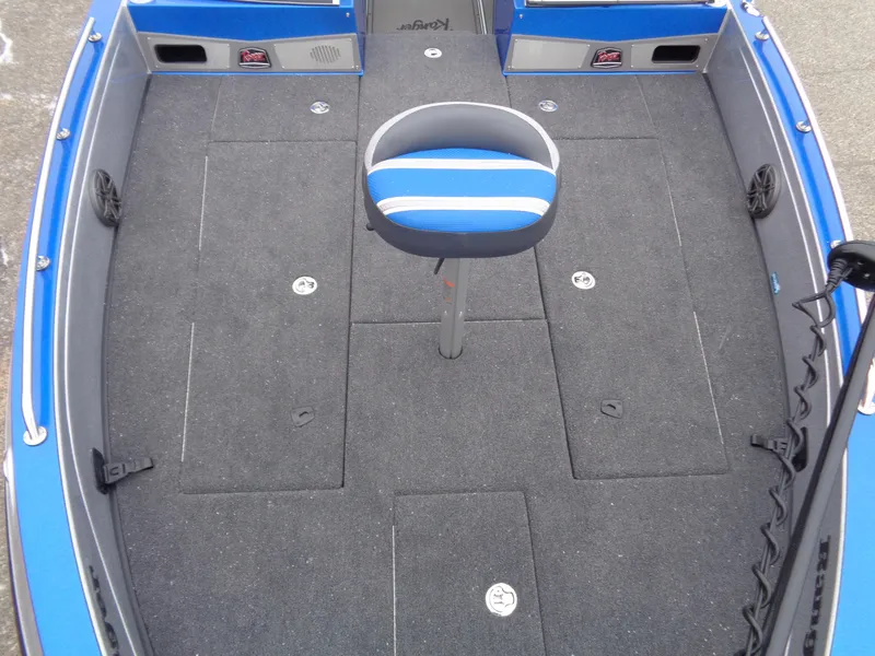 Slide: The Image of 2024 Ranger 622FS Pro boat interior with blue and gray seating and carpeted deck. - 17