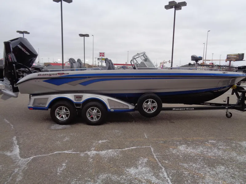 Slide: The Image of 2024 Ranger 622FS Pro boat on trailer, side view, in parking lot. - 3