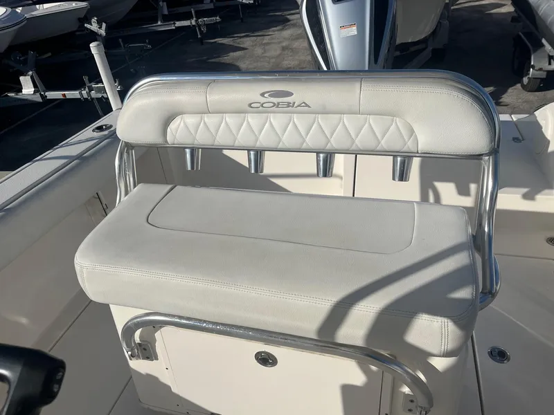 Slide: The Image of 2022 Cobia 237 Center Console boat seat with cushioned backrest and stainless steel frame. - 5