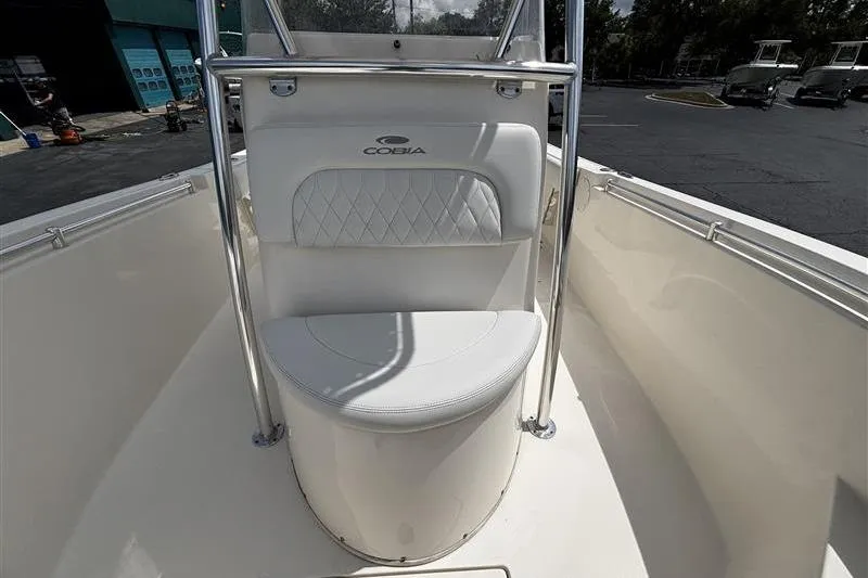 Slide: The Image of 2022 Cobia 237 Center Console boat with white seating and stainless steel railings. - 9