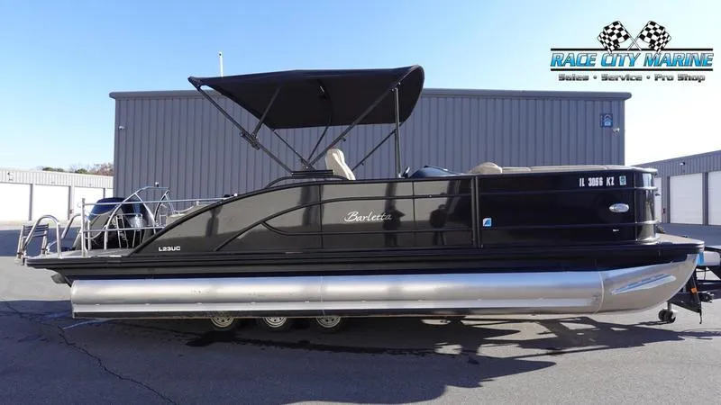 The Image of 2020 Barletta L23UC pontoon boat with black canopy, parked at Race City Marine. - 1