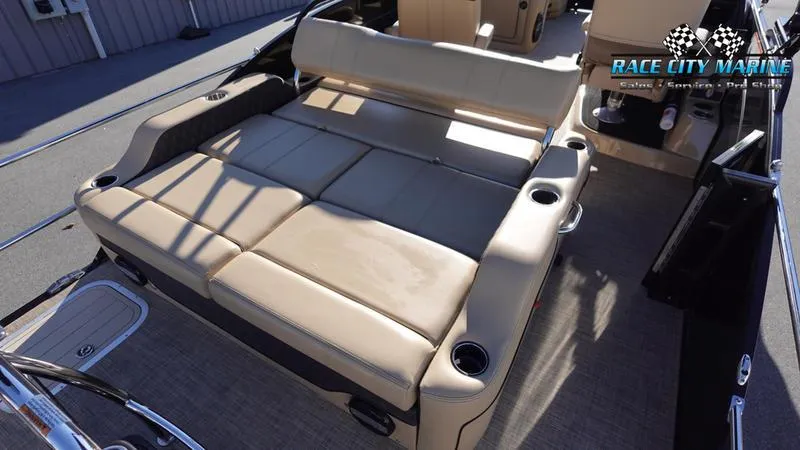 Slide: The Image of 2020 Barletta L23UC boat with spacious beige seating and cup holders. - 12