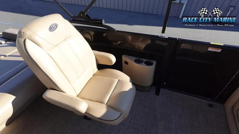 Slide: The Image of Barletta L23UC 2020 boat interior with beige captain's chair and cup holders. - 19