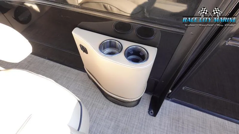 Slide: The Image of 2020 Barletta L23UC boat interior with cup holders and Race City Marine logo. - 20