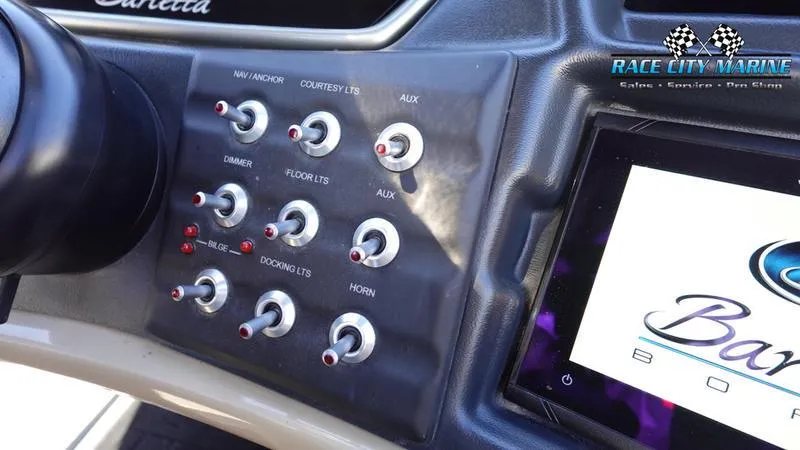 Slide: The Image of Control panel of 2020 Barletta L23UC boat with various switches and Race City Marine logo. - 31