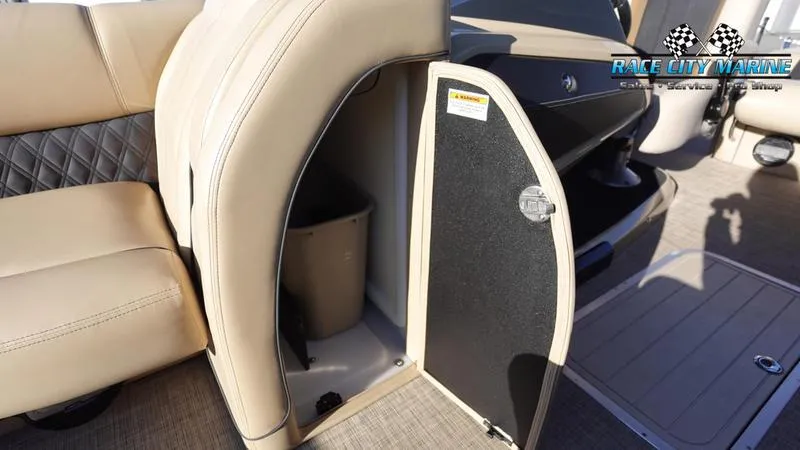 Slide: The Image of 2020 Barletta L23UC boat interior with open storage compartment and beige seating. - 35