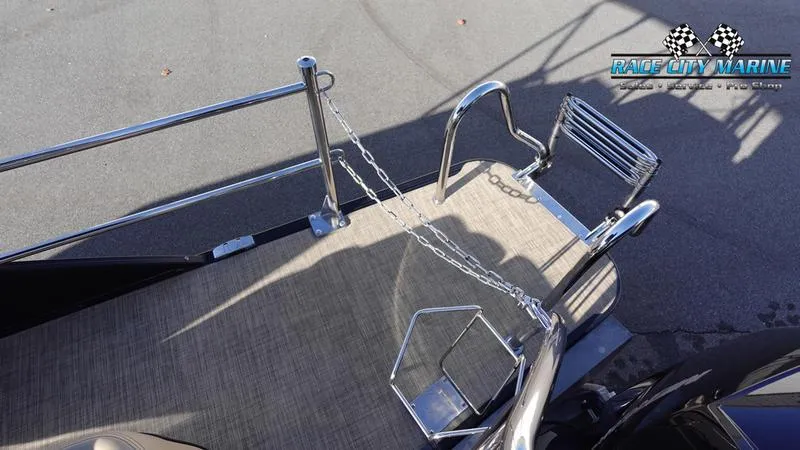 Slide: The Image of 2020 Barletta L23UC boat deck with metal railings and Race City Marine logo. - 9