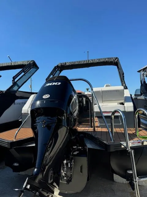 Slide: The Image of 2025 Manitou 22' Explore Navigator boat with powerful outboard motor. - 10
