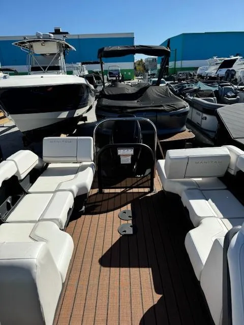 Slide: The Image of 2025 Manitou 22' Explore Navigator pontoon boat with spacious seating and modern design. - 4