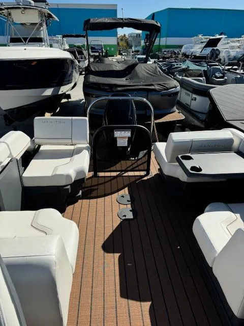Slide: The Image of 2025 Manitou 22' Explore Navigator pontoon boat with spacious seating and modern design. - 5