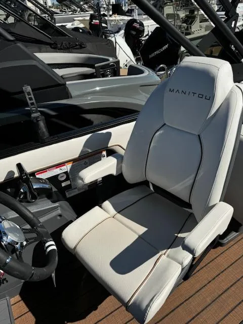 Slide: The Image of 2025 Manitou 22' Explore Navigator boat seat, luxurious design, white upholstery. - 7