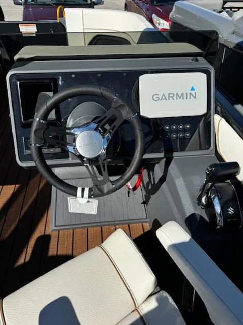 Slide: The Image of 2025 Manitou 22' Explore Navigator dashboard with Garmin navigation system. - 8