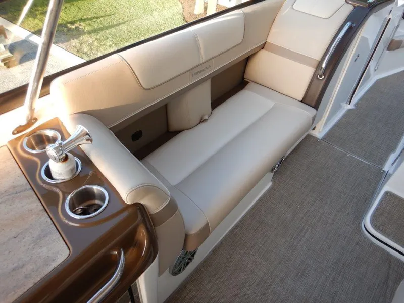 Slide: The Image of 2016 Formula 350 Crossover Bowrider interior with beige seating and cup holders. - 11